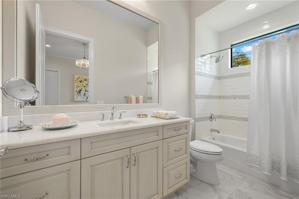 11681 Bald Eagle Way Naples, FL 34120 - Photo 31 of 50 a bathroom with a granite countertop sink toilet and shower