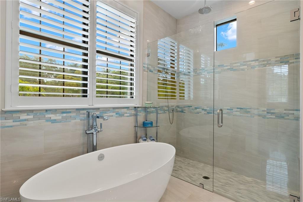 11681 Bald Eagle Way Naples, FL 34120 - Photo 33 of 50 a bathroom with a bathtub and shower