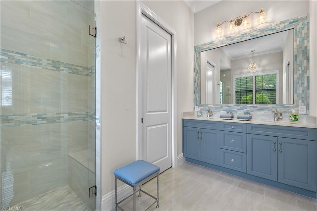 11681 Bald Eagle Way Naples, FL 34120 - Photo 35 of 50 a bathroom with a double vanity sink mirror and shower
