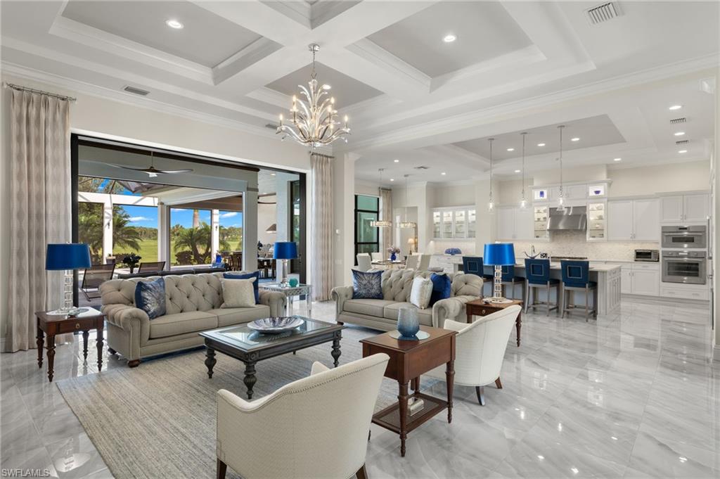 11681 Bald Eagle Way Naples, FL 34120 - Photo 5 of 50 a living room with furniture kitchen view and a chandelier