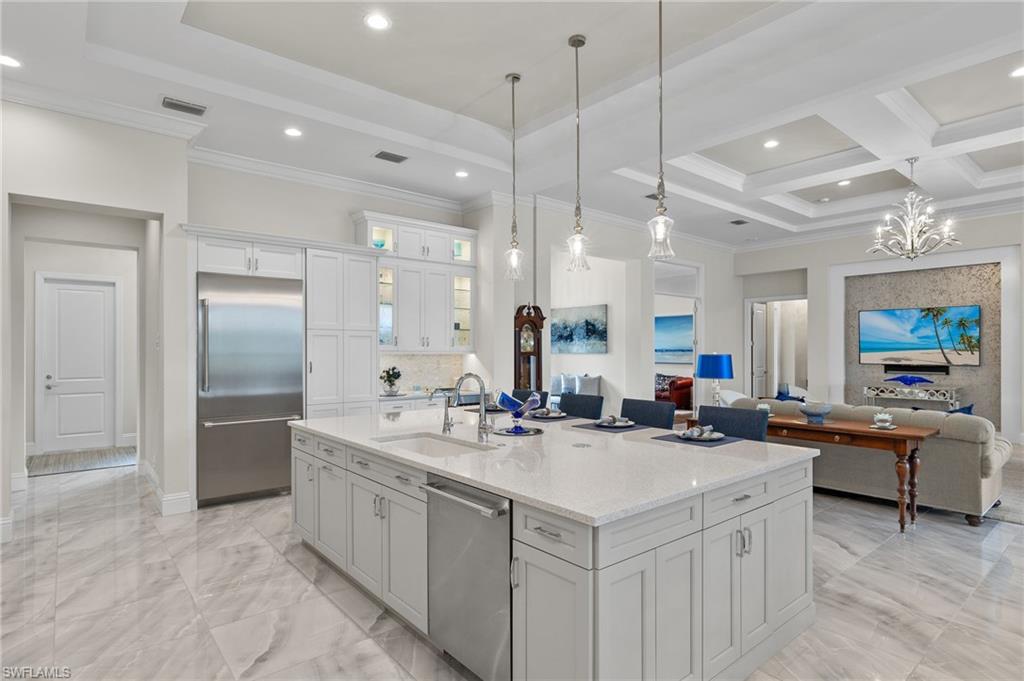 11681 Bald Eagle Way Naples, FL 34120 - Photo 9 of 50 a kitchen with a sink stove and refrigerator