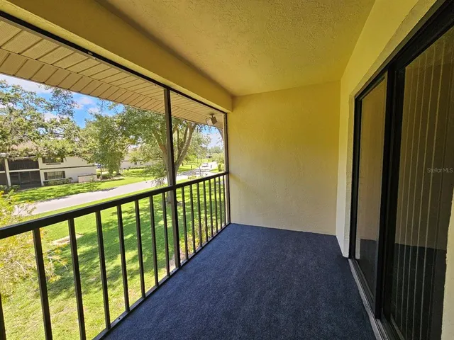 a view of an empty room with a chandelier fan