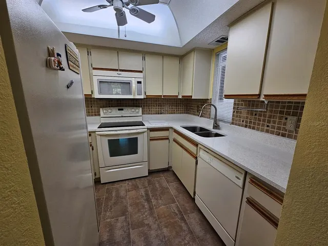 a kitchen with appliances cabinets and a sink