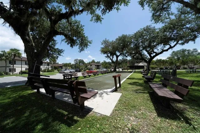 a swimming pool with outdoor seating and yard