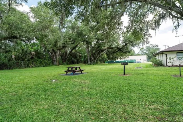 a view of a livingroom with furniture and a bookshelf