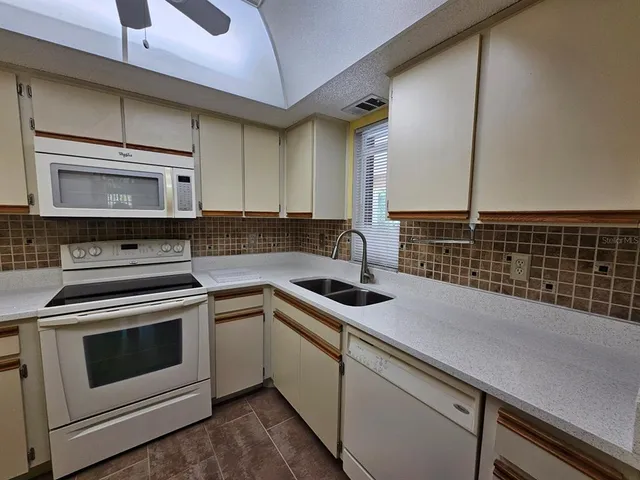 a stove top oven sitting inside of a kitchen