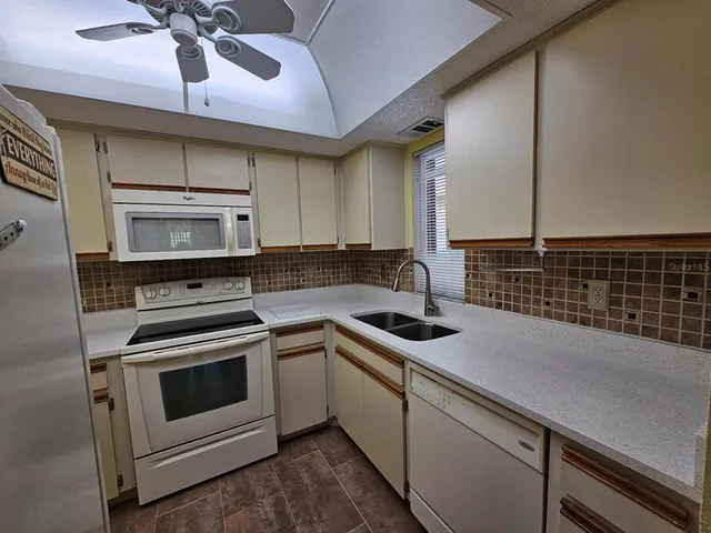 a utility room with closet and wooden floor
