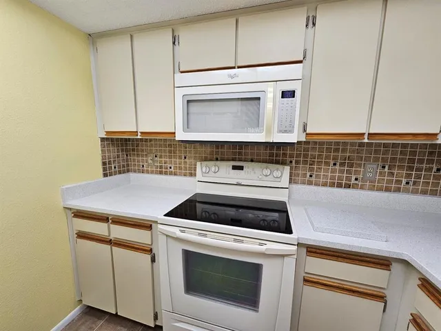 a view of a storage and utility room with a washer dryer