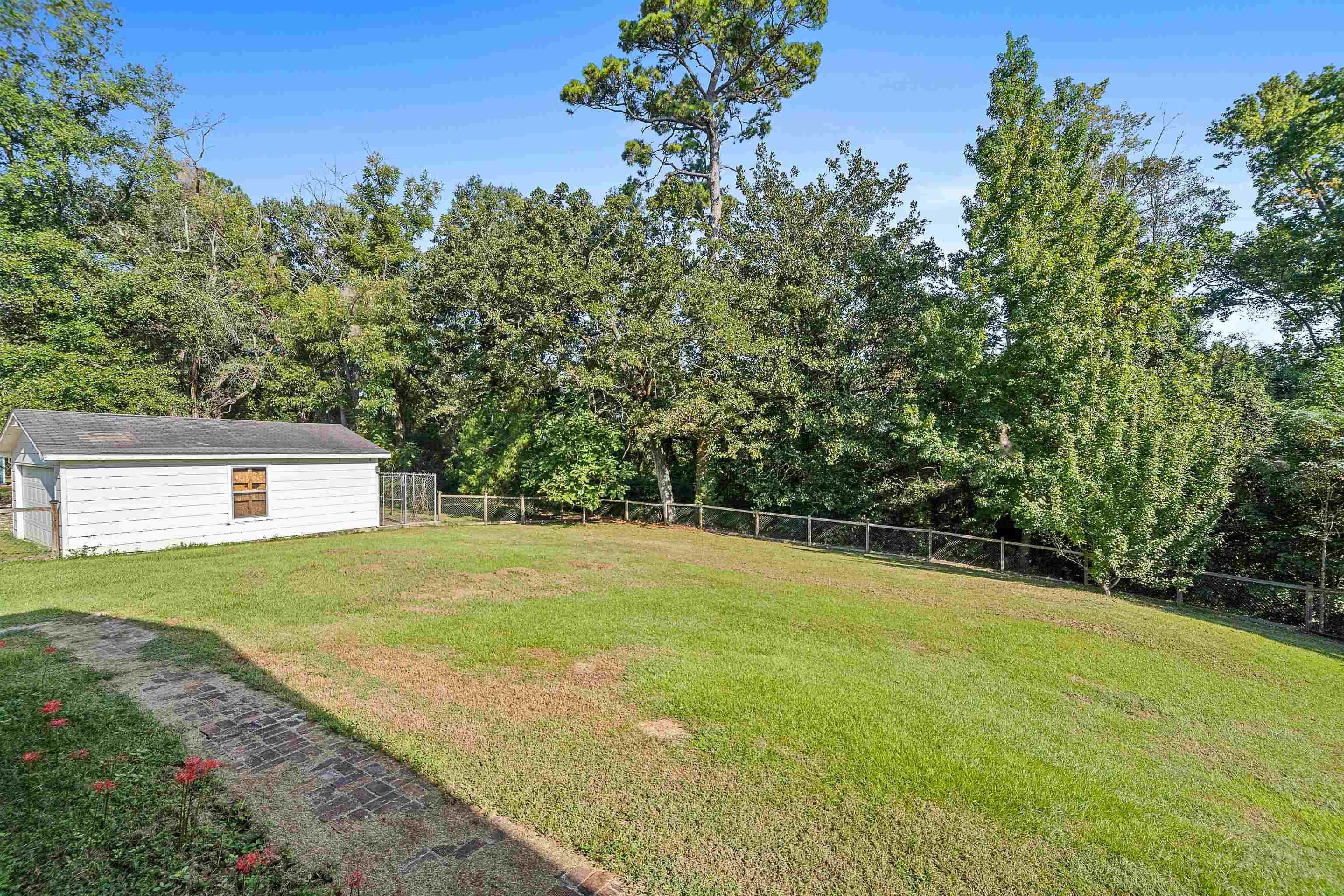 9350 Tompkins Road Stockton, AL 36579 - Photo 30 of 36 Fenced backyard with an outdoor structure and view of scattered trees