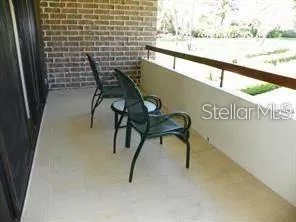 a view of a chairs and table in the balcony