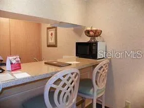 a bedroom with a bed and a lamp on dresser