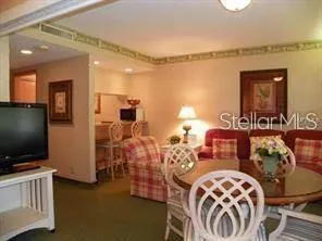 a bedroom with furniture and a flat screen tv