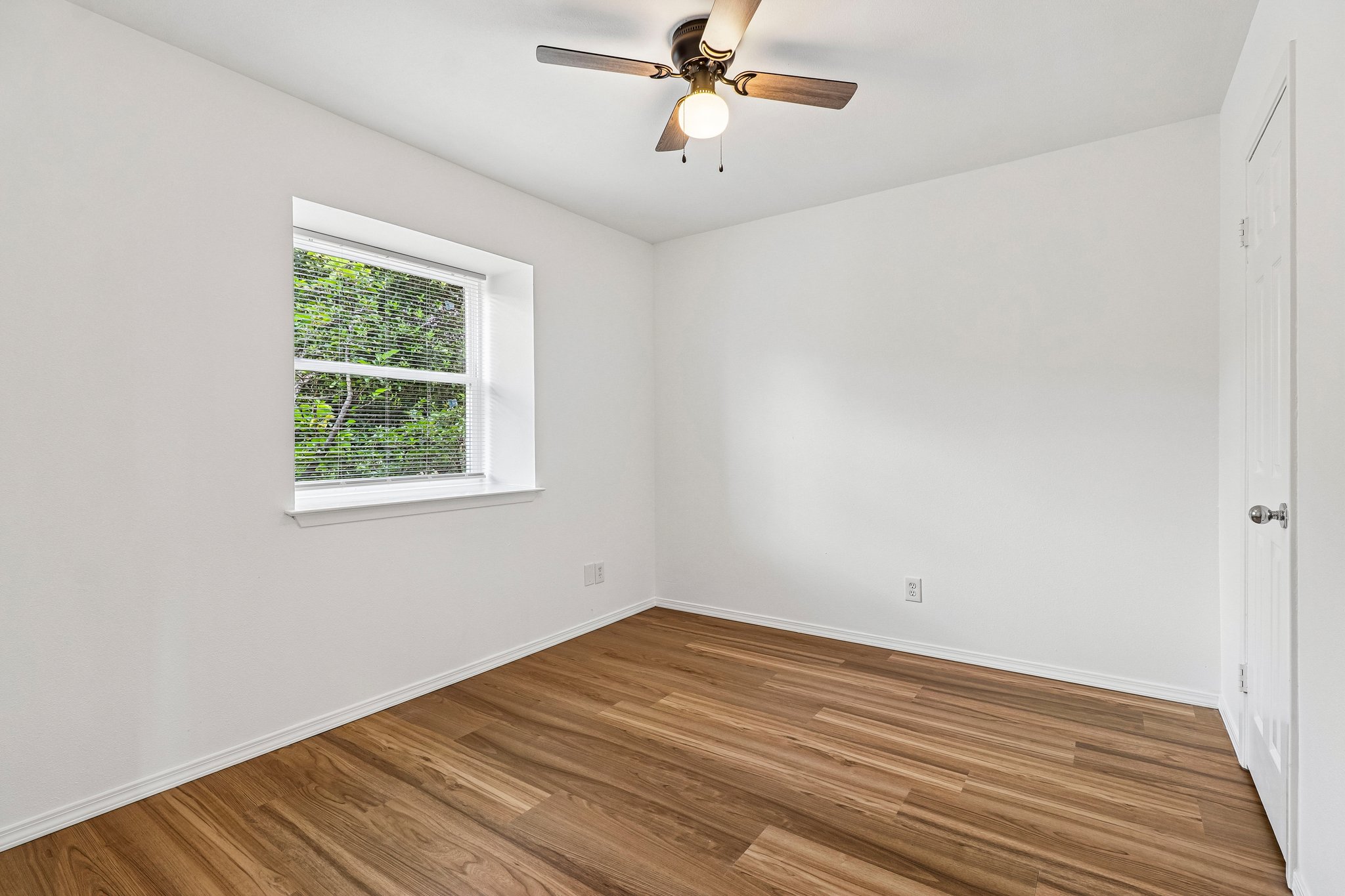 5809 Coventry Lane Austin, TX 78723 - Photo 19 of 35 Upstairs beedroom with wood plank flooring with beautiful stool window.