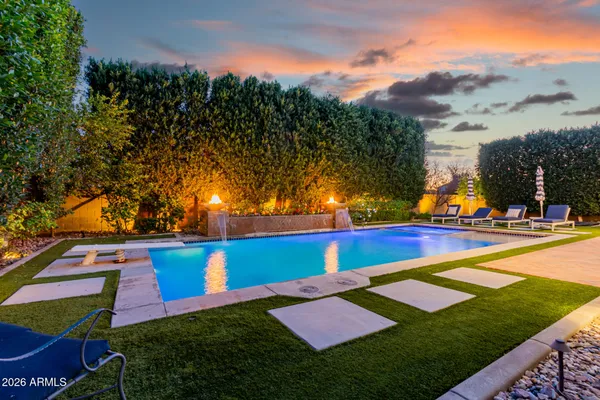 a large white kitchen with lots of counter top space a sink and cabinets