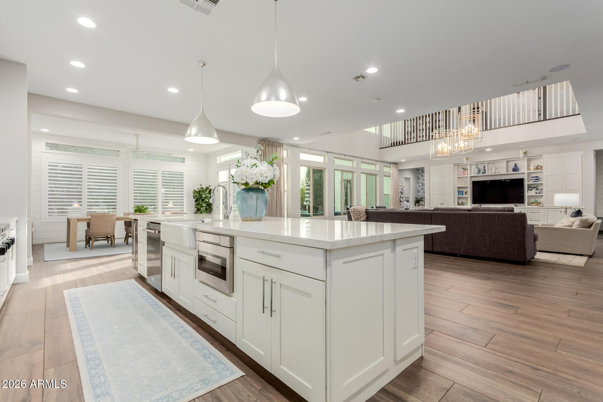 2917 East Boot Track Trail Gilbert, AZ 85296 - Photo 21 of 93 a large white kitchen with stainless steel appliances granite countertop a stove and a sink