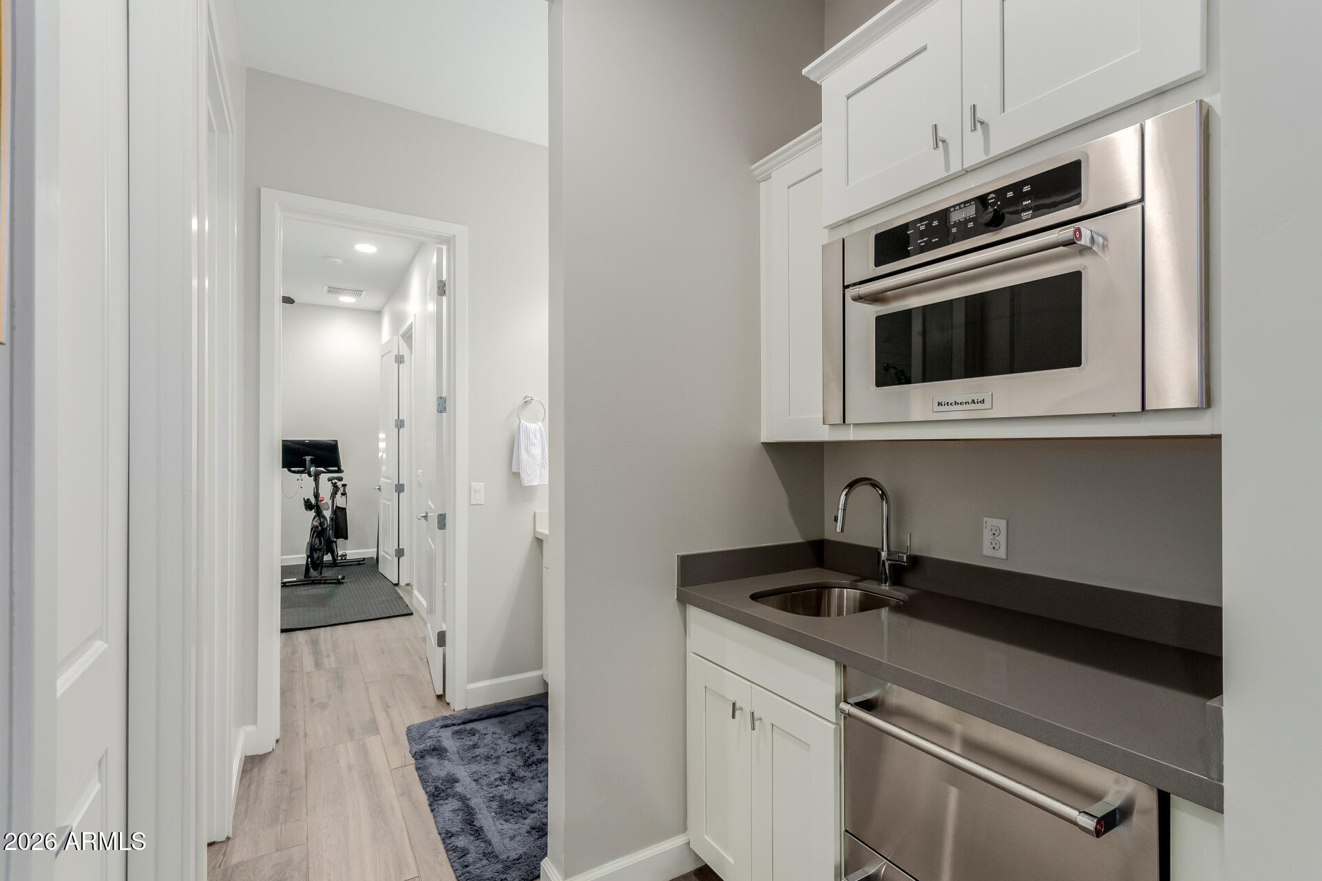 2917 East Boot Track Trail Gilbert, AZ 85296 - Photo 32 of 93 a kitchen with stainless steel appliances a stove microwave and refrigerator