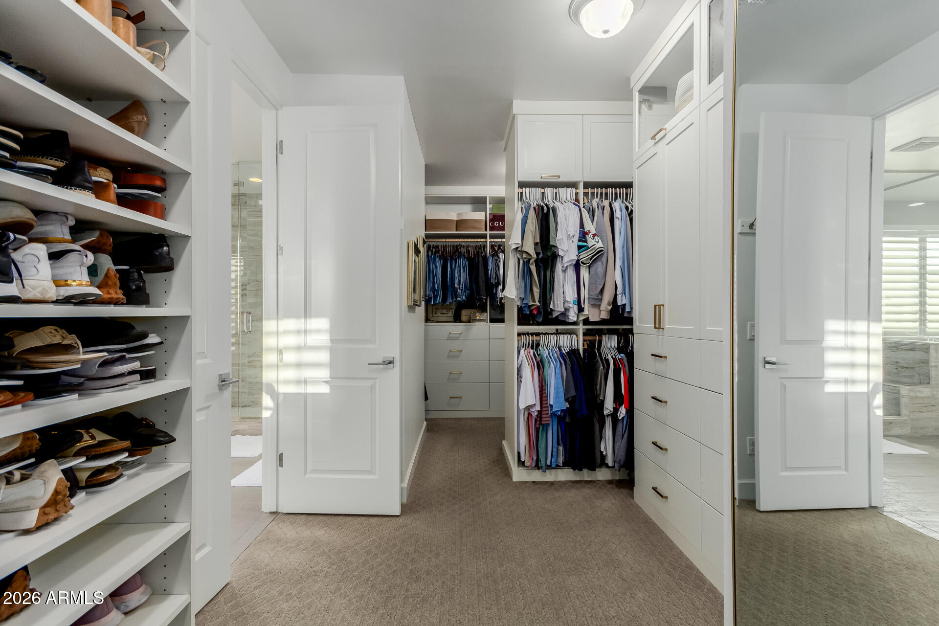 2917 East Boot Track Trail Gilbert, AZ 85296 - Photo 48 of 93 a view of walk in closet with clothes and shoes