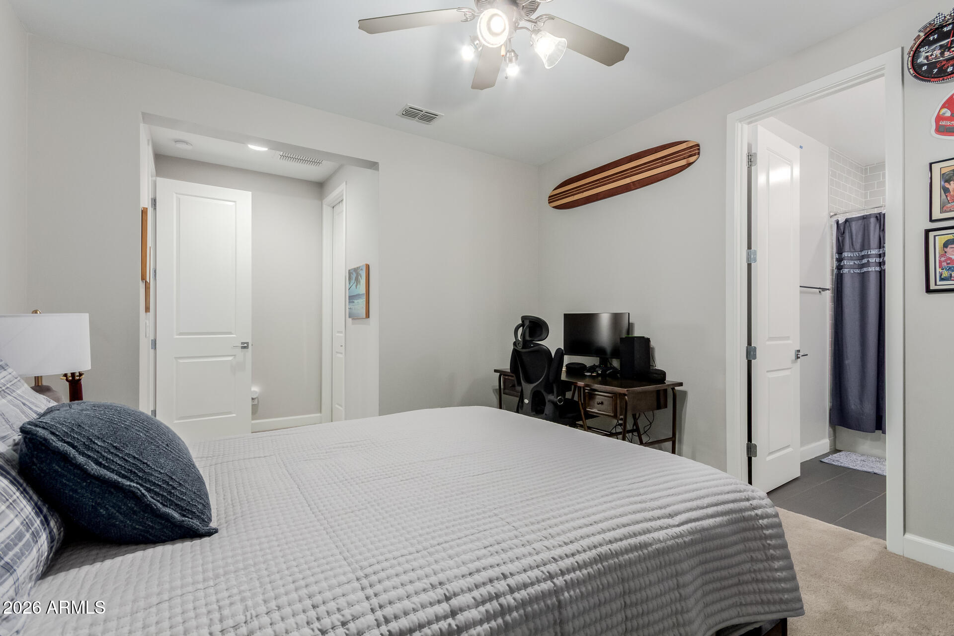 2917 East Boot Track Trail Gilbert, AZ 85296 - Photo 52 of 93 a bedroom with a bed and a chandelier