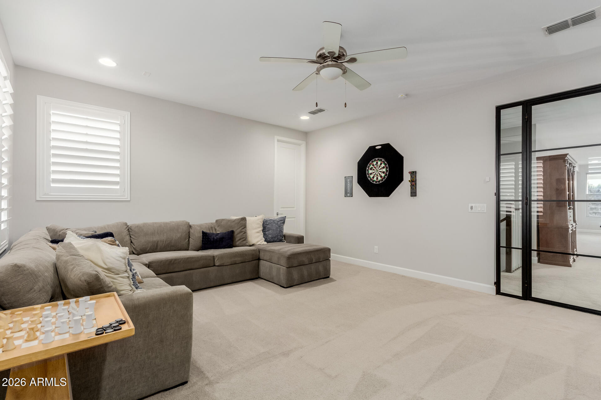 2917 East Boot Track Trail Gilbert, AZ 85296 - Photo 61 of 93 a living room with furniture a chandelier and a window
