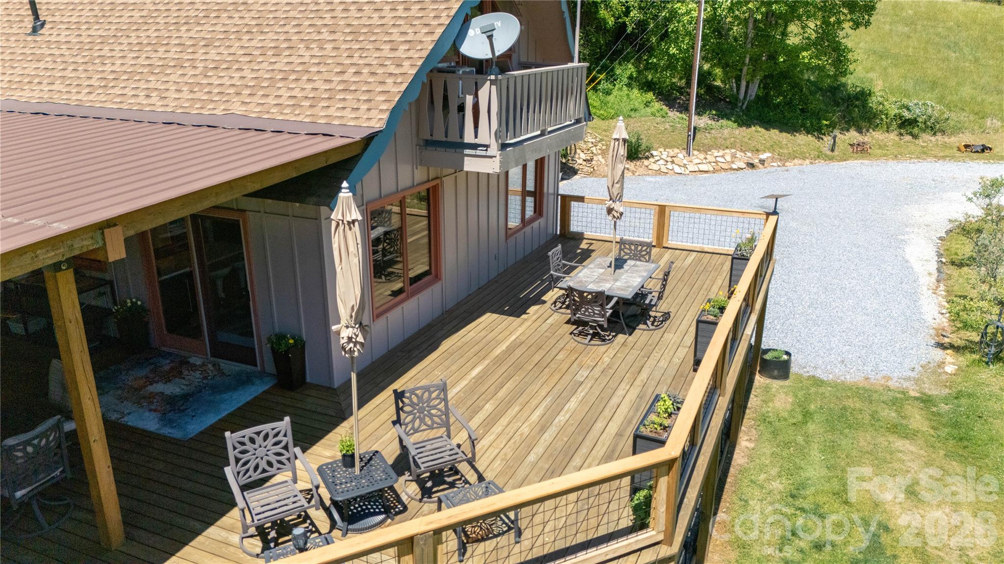 93 Franklin Crest Road Spruce Pine, NC 28777 - Photo 10 of 47 a view of balcony with wooden floor and outdoor seating