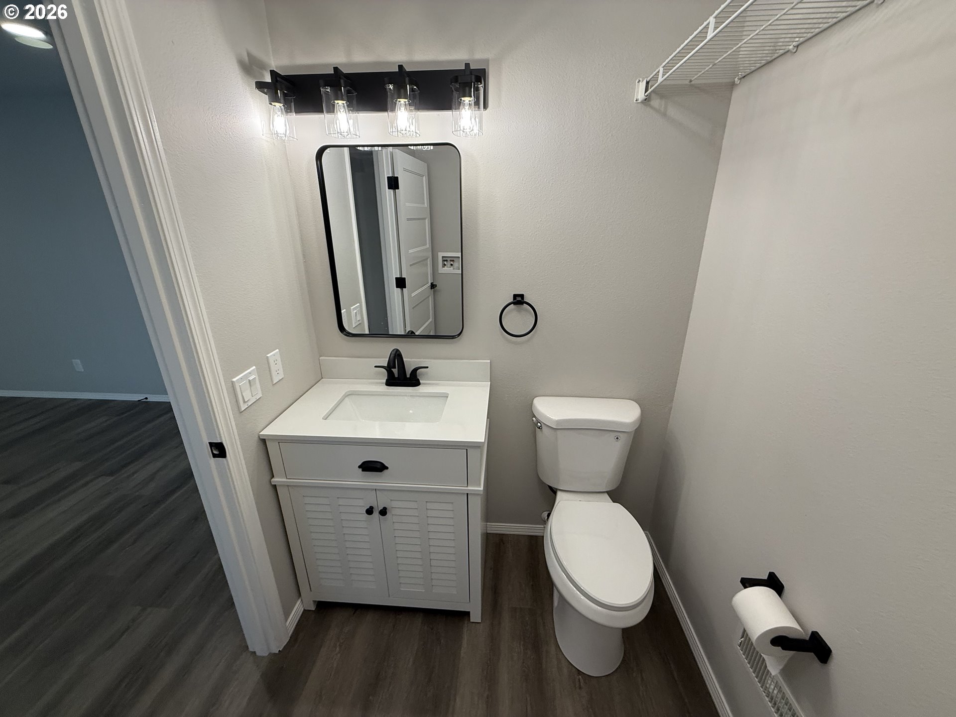 7025 Southwest 164th Terrace Beaverton, OR 97007 - Photo 13 of 28 a bathroom with a toilet sink and mirror
