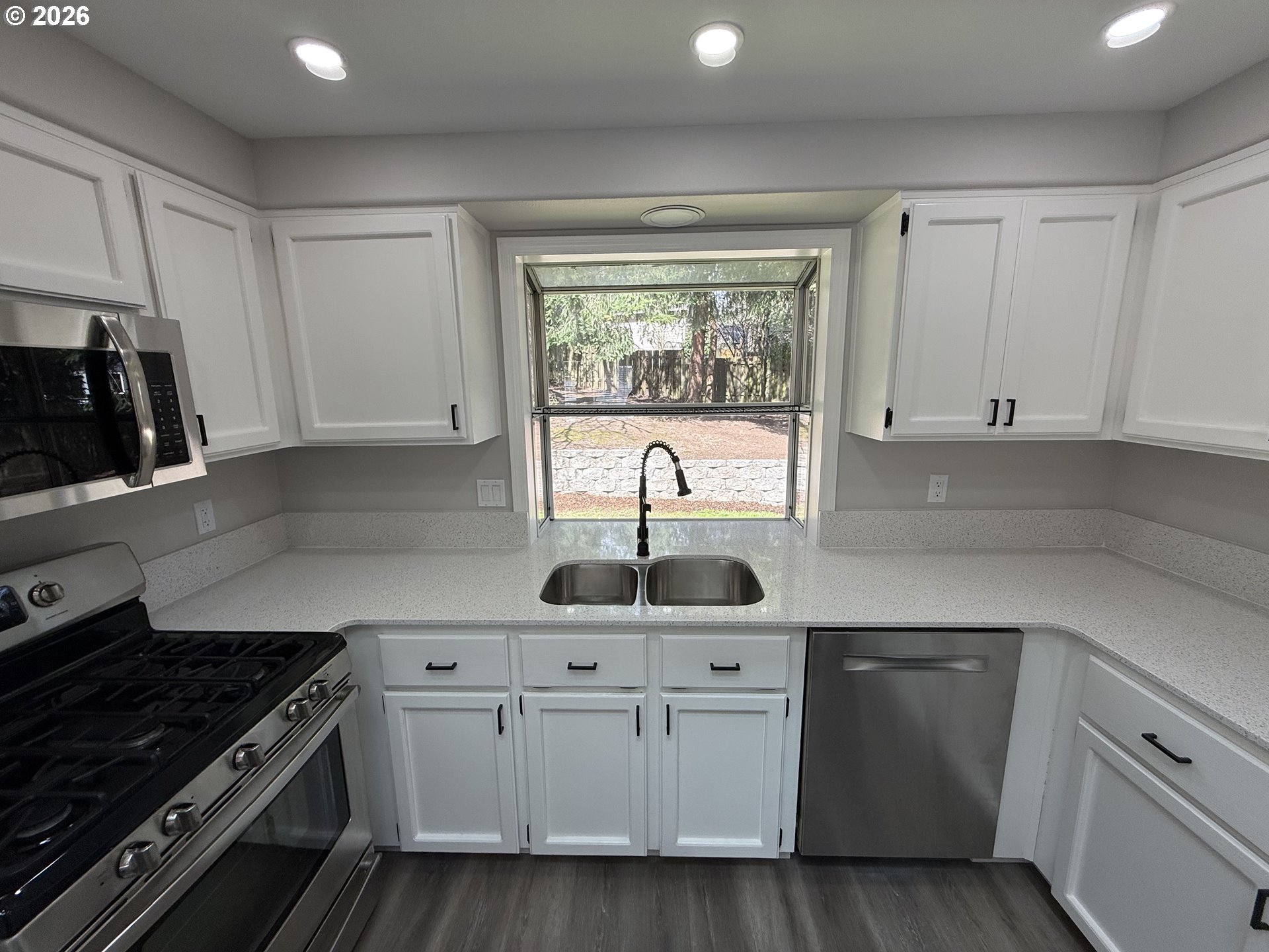 7025 Southwest 164th Terrace Beaverton, OR 97007 - Photo 15 of 28 a kitchen with white cabinets and sink