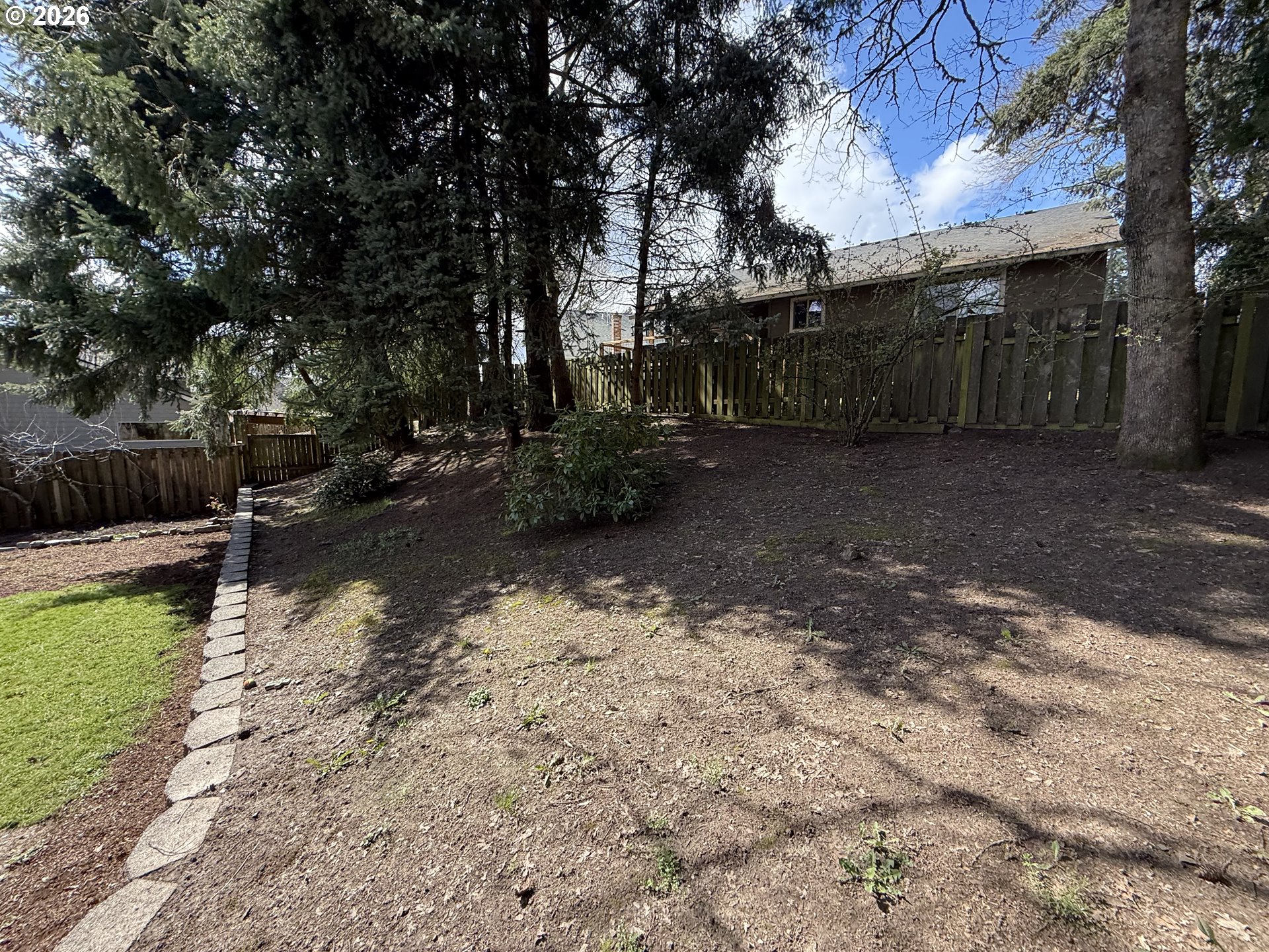 7025 Southwest 164th Terrace Beaverton, OR 97007 - Photo 26 of 28 a view of a backyard with a tree