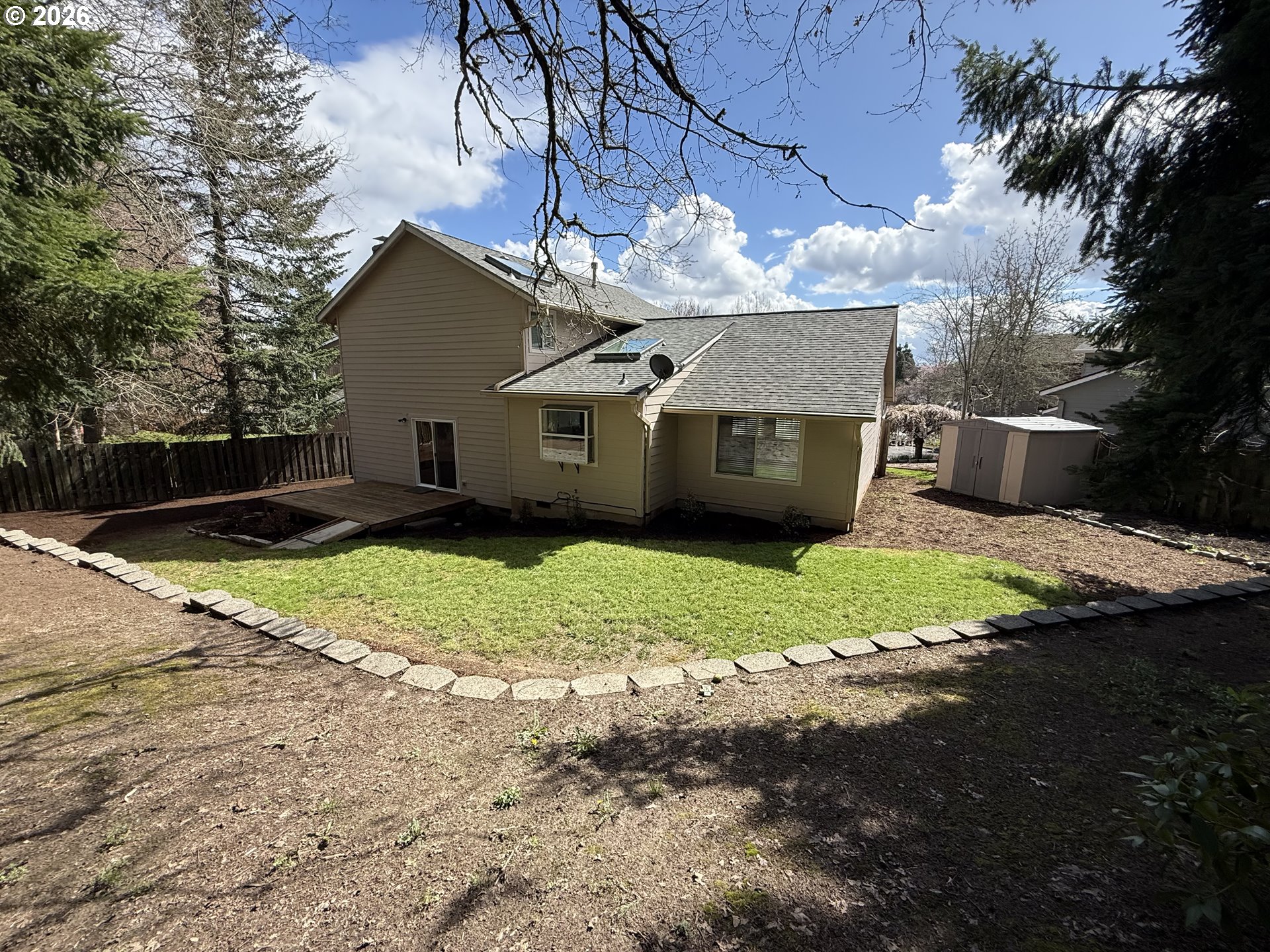 7025 Southwest 164th Terrace Beaverton, OR 97007 - Photo 27 of 28 a view of a house with a yard and large tree
