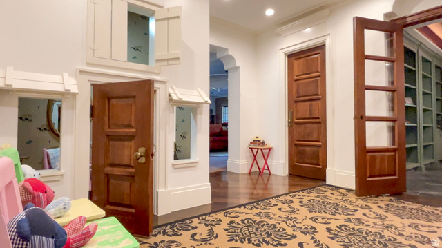 426 West Center Street Parowan, UT 84761 - Photo 56 of 107 Hardwood flooring throughout the entry, featuring a decorative area rug and a solid wood paneled door