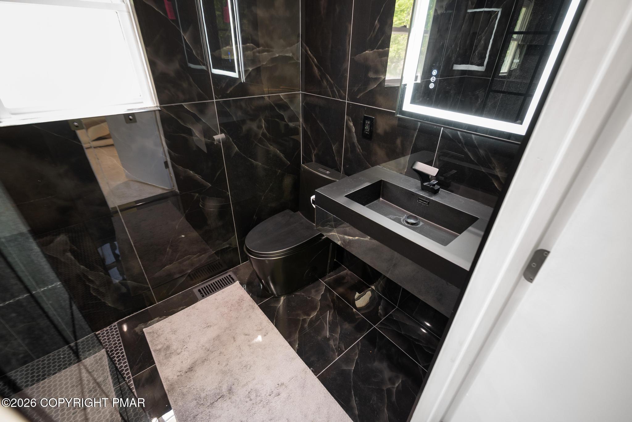 2312 Cramer Court Bushkill, PA 18324 - Photo 25 of 37 a bathroom with a sink a toilet and a shower