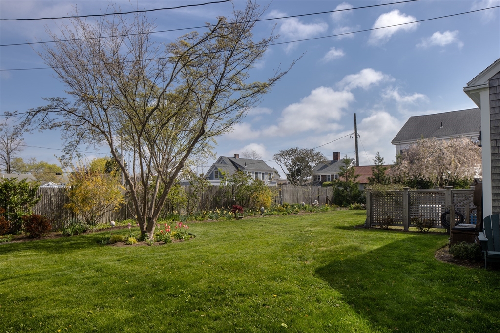 31 Main Street Marion, MA 02738 - Photo 13 of 29 a backyard of a house with lots of green space