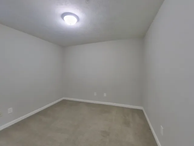 an empty room with a empty space and windows