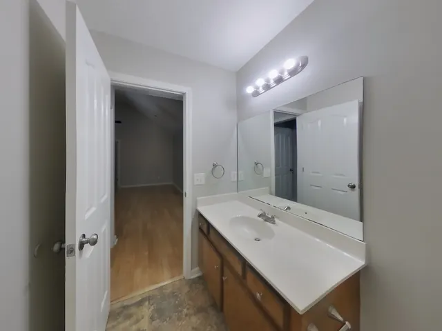 a bathroom with a toilet a sink and mirror