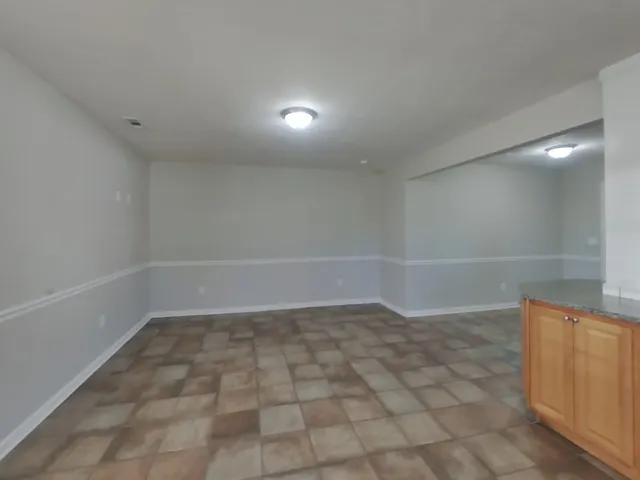 a view of a room with wooden floor and white walls