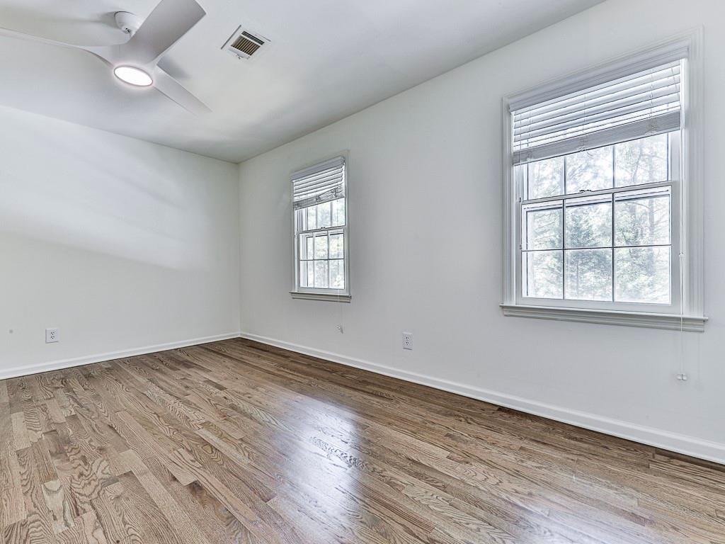 633 Butterworth Road Canton, GA 30114 - Photo 31 of 55 an empty room with wooden floor and windows