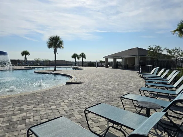 a view of a swimming pool with lawn chairs
