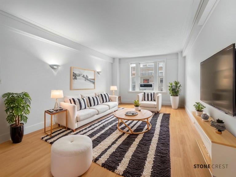 a bedroom with furniture and a flat screen tv