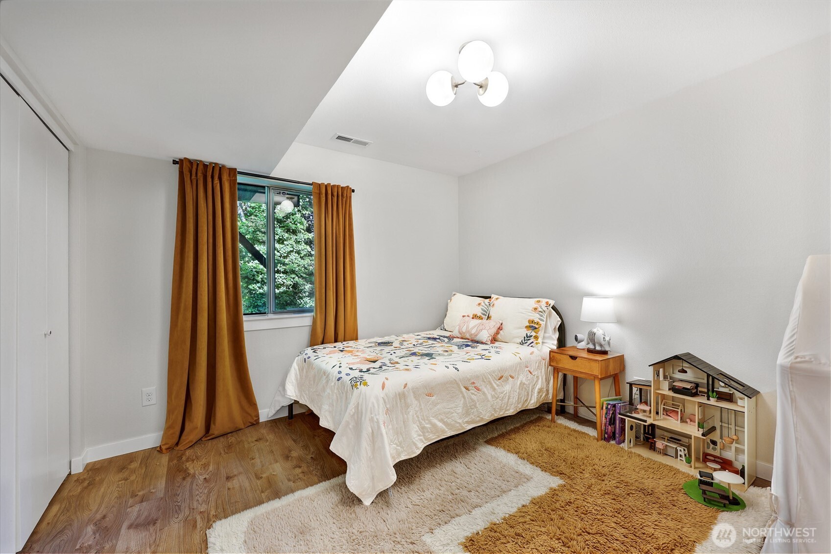5126 South Garden Loop Road, Unit 11 Seattle, WA 98118 - Photo 26 of 36 a bedroom with a bed and a window