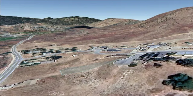 a view of a mountain with wooden fence