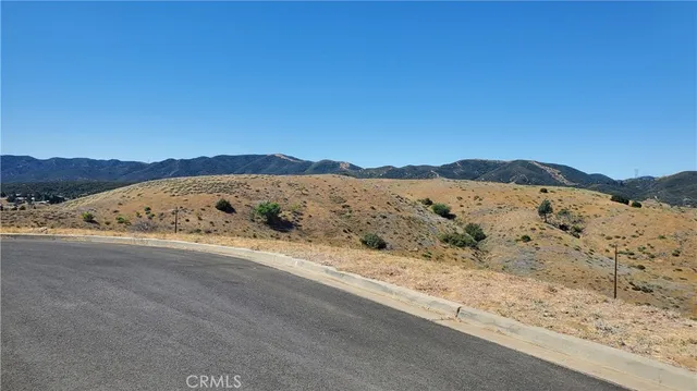 a view of a large mountain with mountains in the background