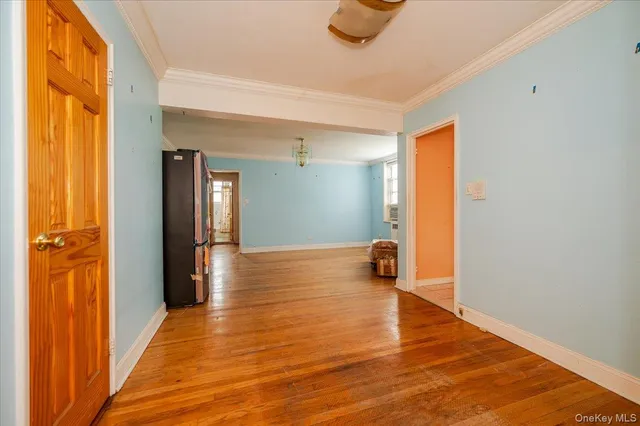 a view of a room with wooden floor and a window