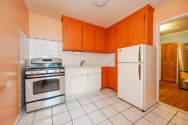 a kitchen with a refrigerator sink and cabinets