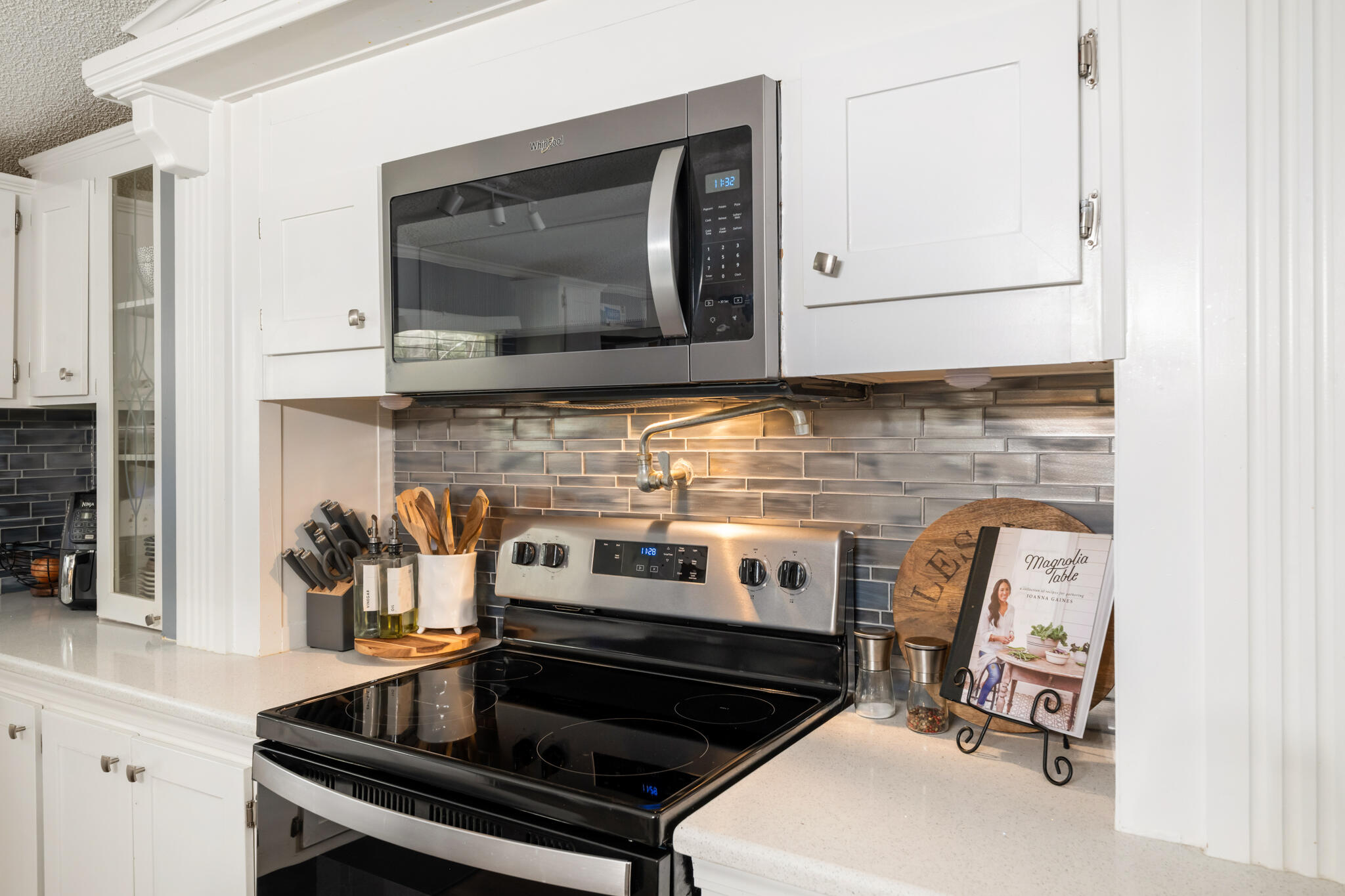 2422 Crescent Wood Road Navarre, FL 32566 - Photo 14 of 42 a kitchen with a stove and a microwave