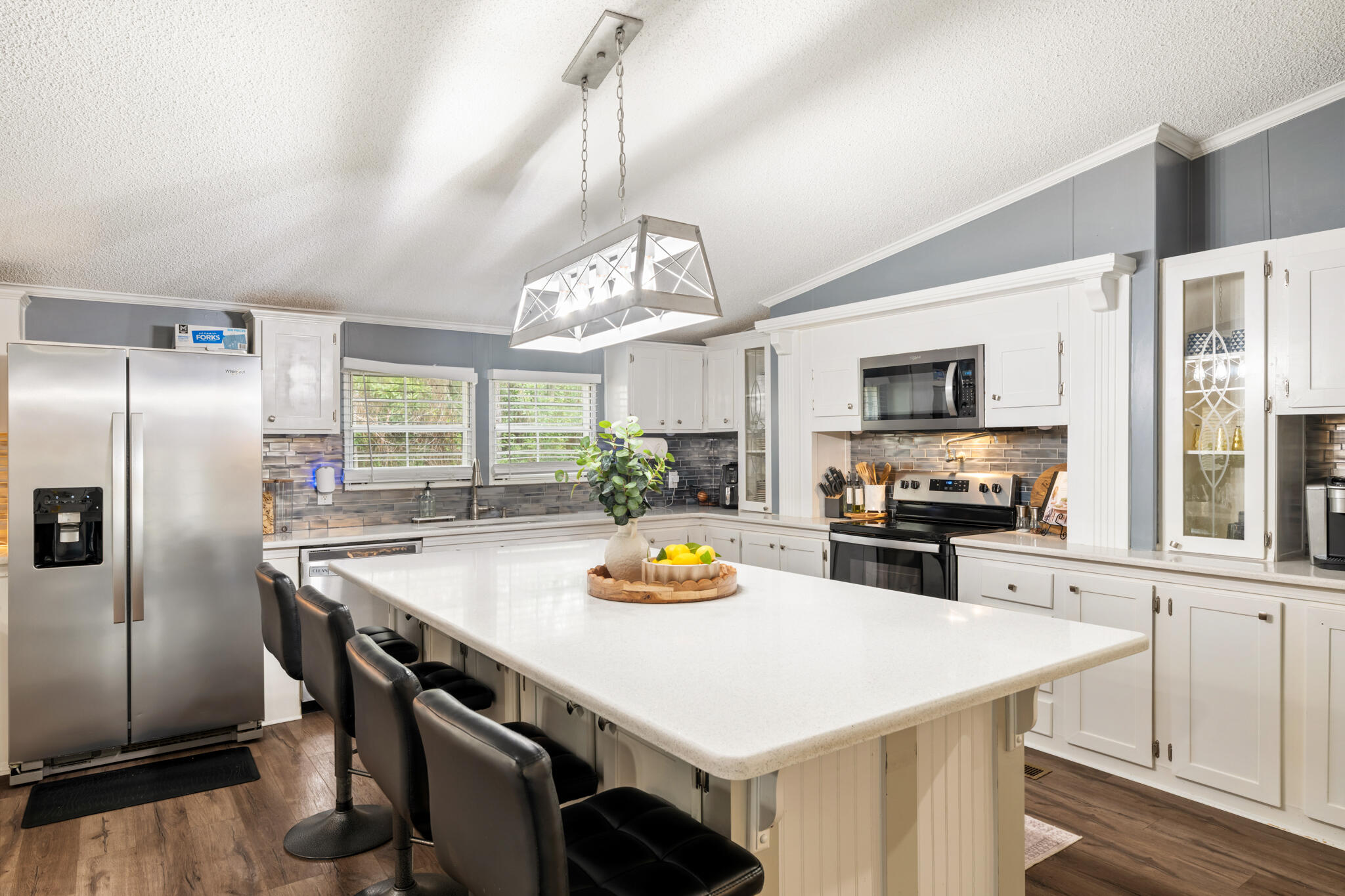 2422 Crescent Wood Road Navarre, FL 32566 - Photo 15 of 42 a kitchen with stainless steel appliances granite countertop a sink a stove and a refrigerator