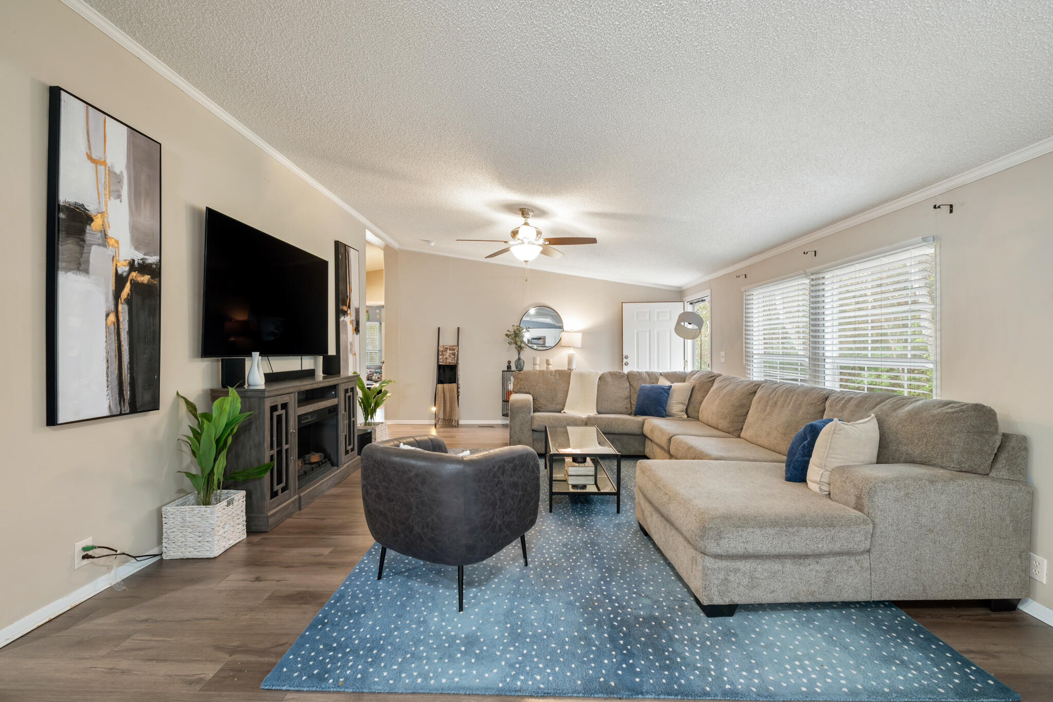 2422 Crescent Wood Road Navarre, FL 32566 - Photo 18 of 42 a living room with furniture a flat screen tv and a large window
