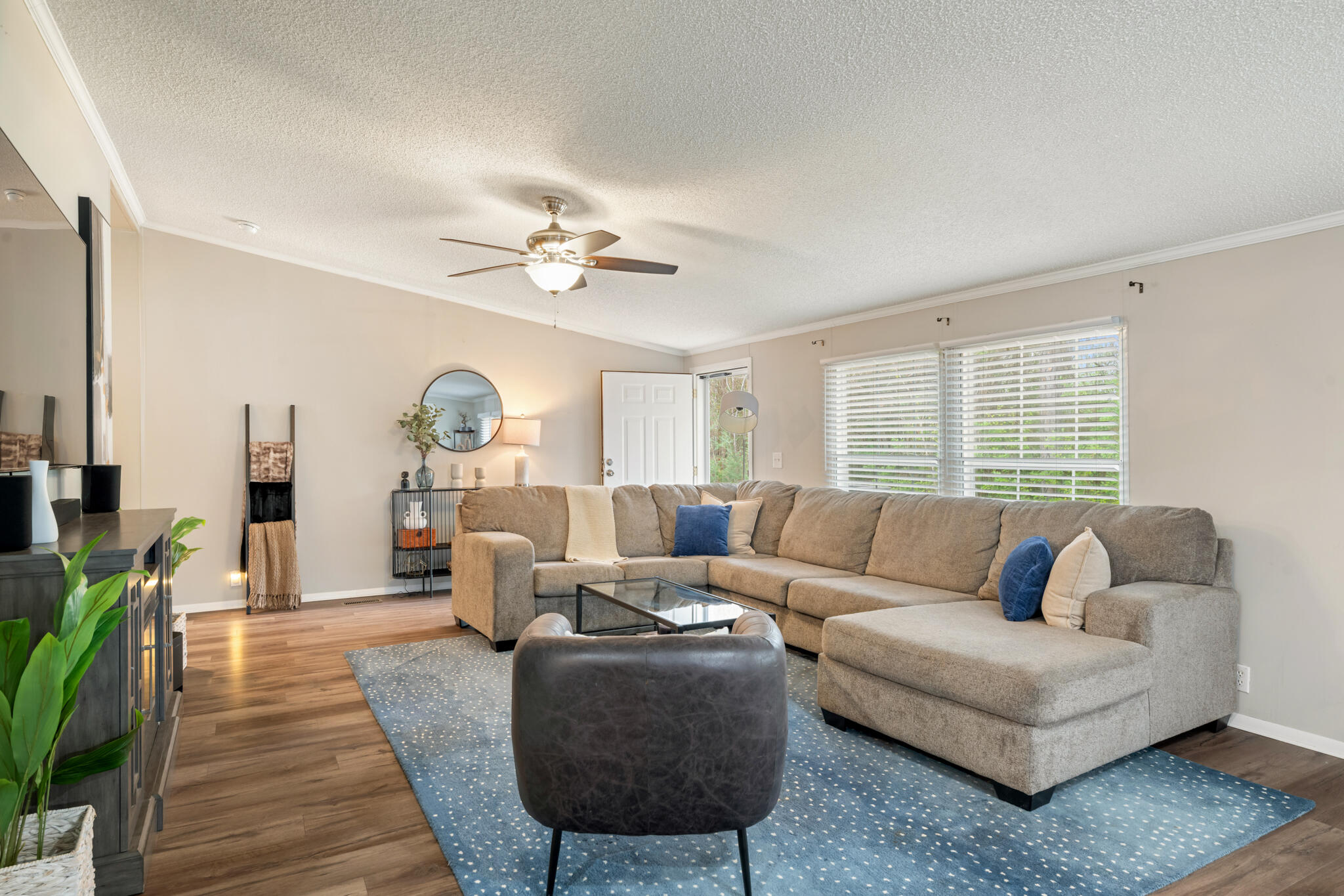2422 Crescent Wood Road Navarre, FL 32566 - Photo 19 of 42 a living room with furniture ceiling fan and a wooden floor