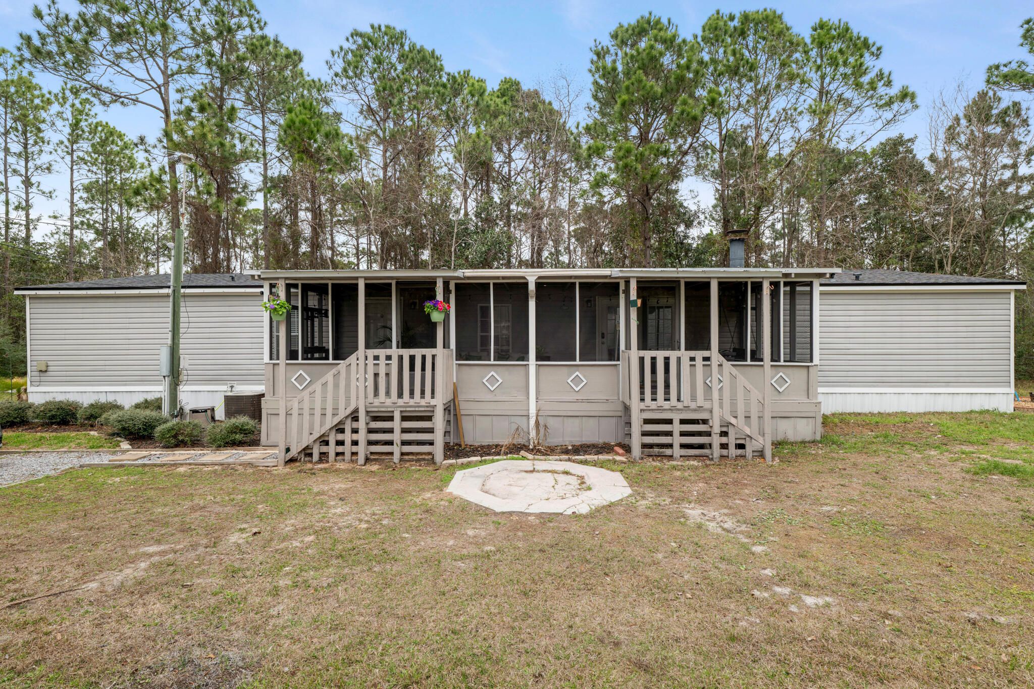 2422 Crescent Wood Road Navarre, FL 32566 - Photo 2 of 42 a view of a chair and table in the backyard