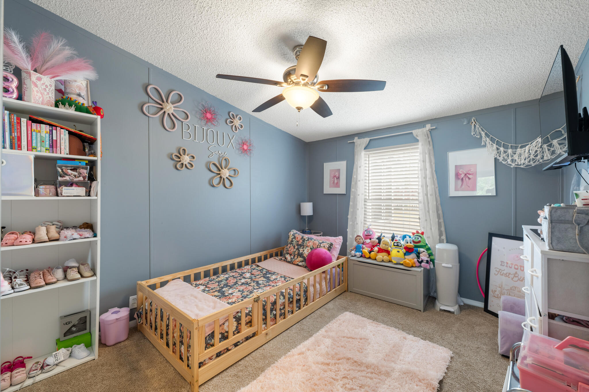 2422 Crescent Wood Road Navarre, FL 32566 - Photo 21 of 42 a bedroom with a bed and a chandelier