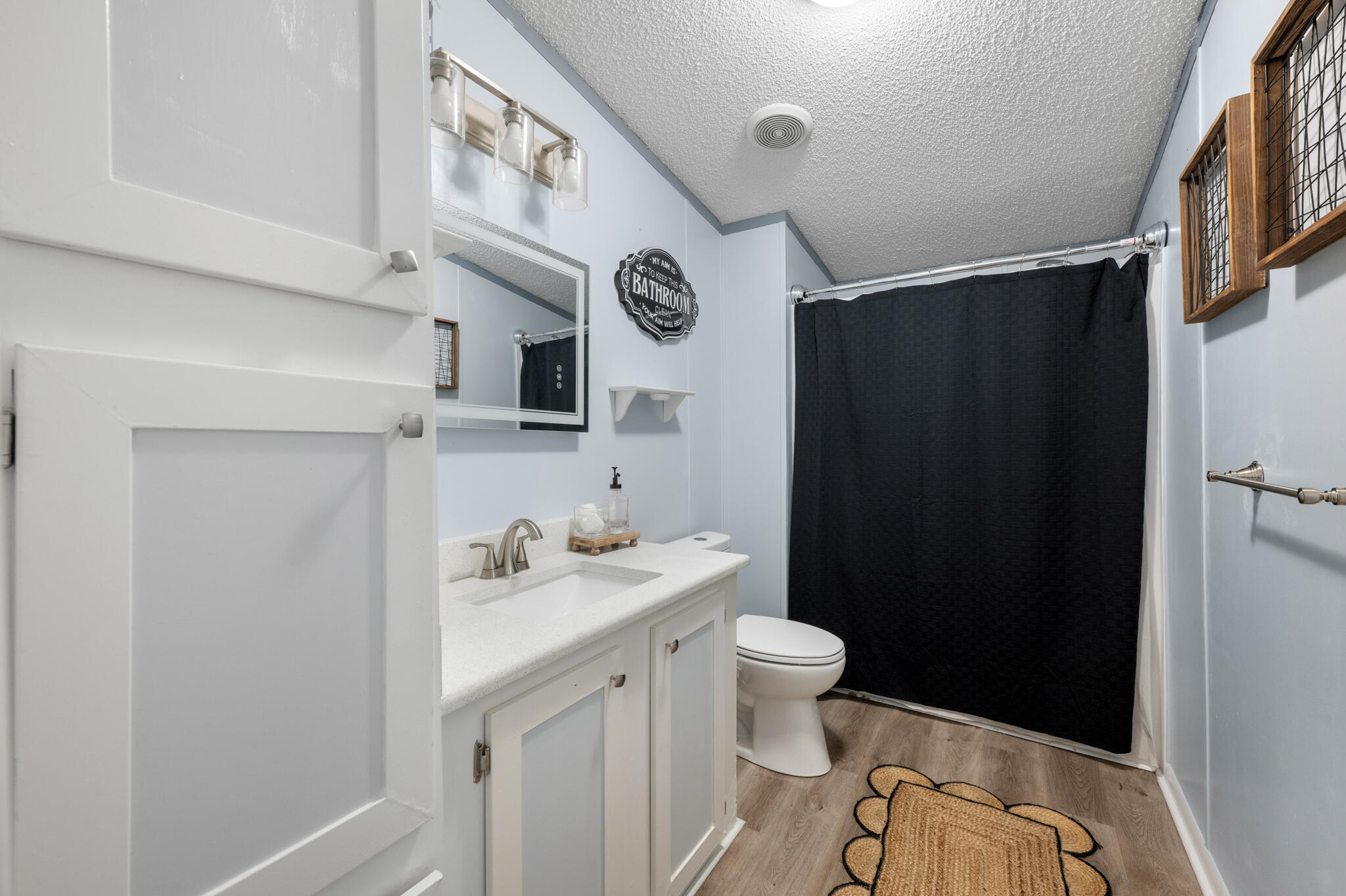 2422 Crescent Wood Road Navarre, FL 32566 - Photo 22 of 42 a bathroom with a sink a toilet and a shower