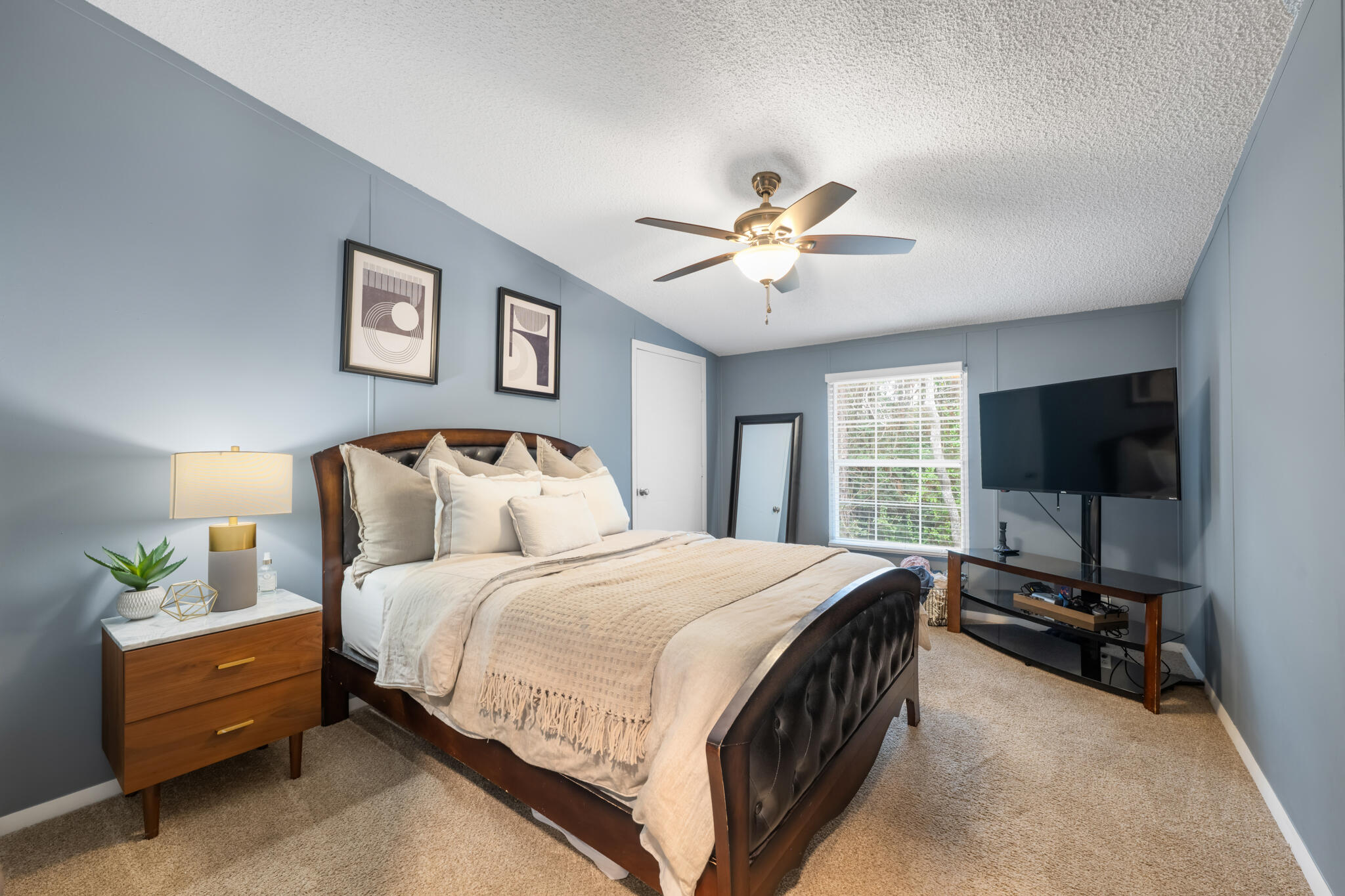 2422 Crescent Wood Road Navarre, FL 32566 - Photo 24 of 42 a bedroom with a bed a window and a flat screen tv